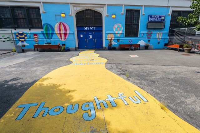A photo of the colorful yellow pathway in front of Middle School 577 in Williamsburg